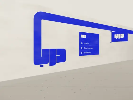A lobby wall band running into the mark, with a directory and blade sign