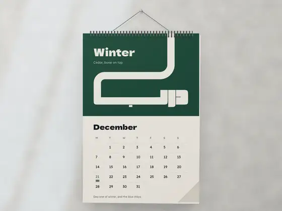 A wall calendar in winter cedar green